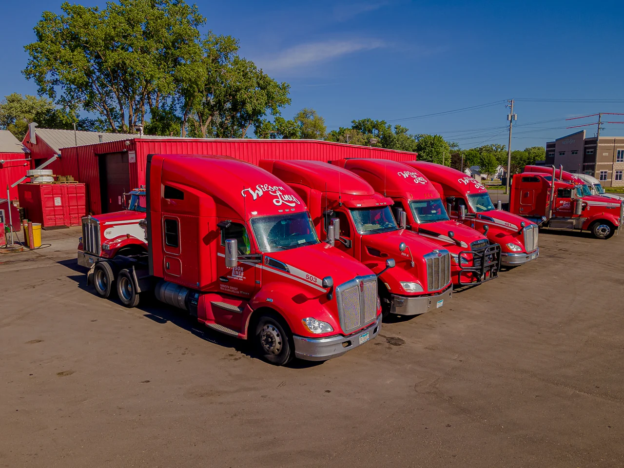 Wilson Lines red trucks lined up in the fleet yard